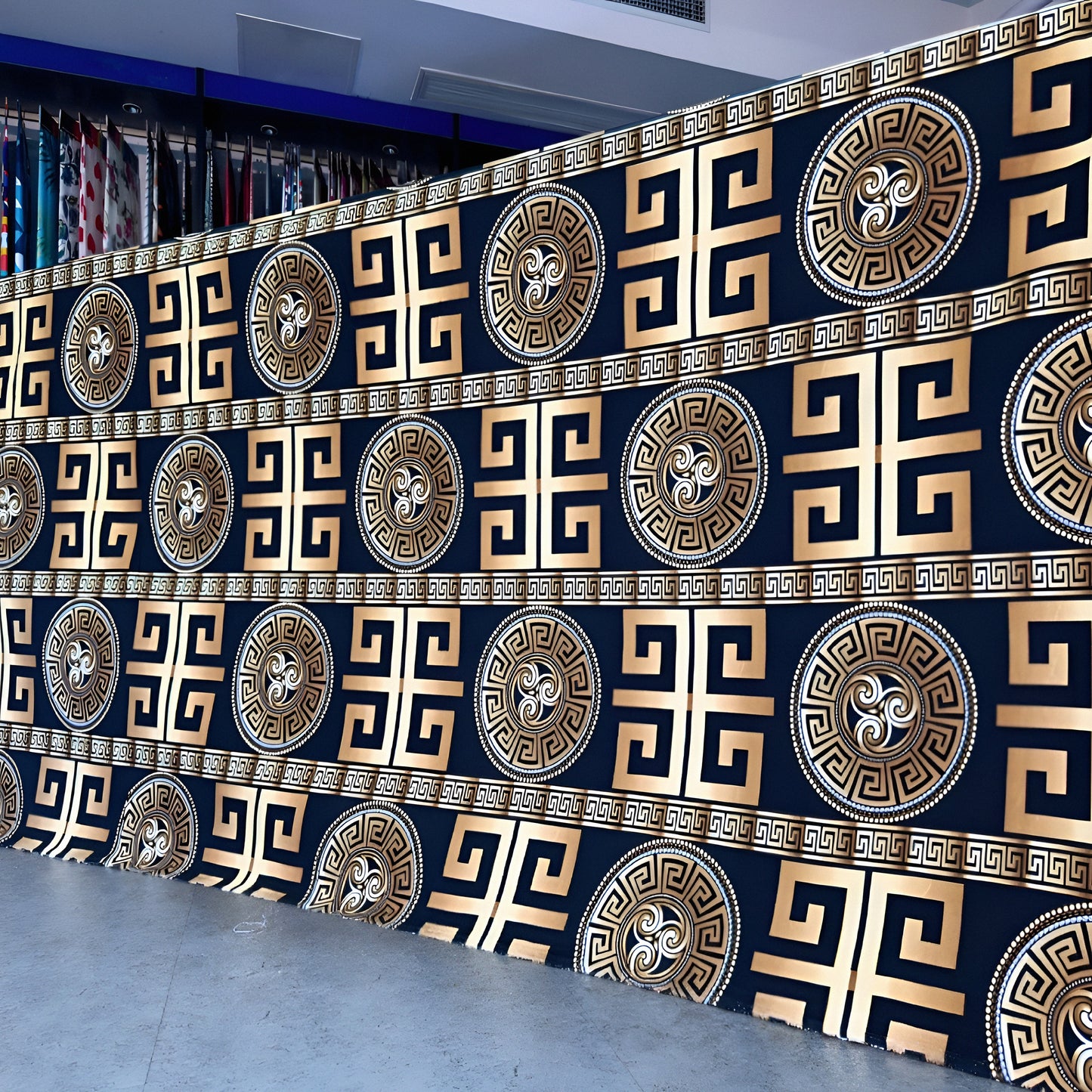 Black bedsheet with gold geometric pattern displayed in showroom — luxury solid-color bedding.