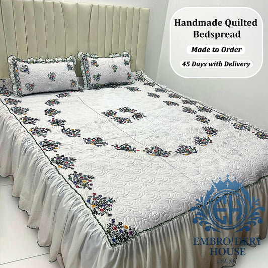 Luxury handmade white embroidered quilted bedspread set with matching pillow covers in Dubai UAE.