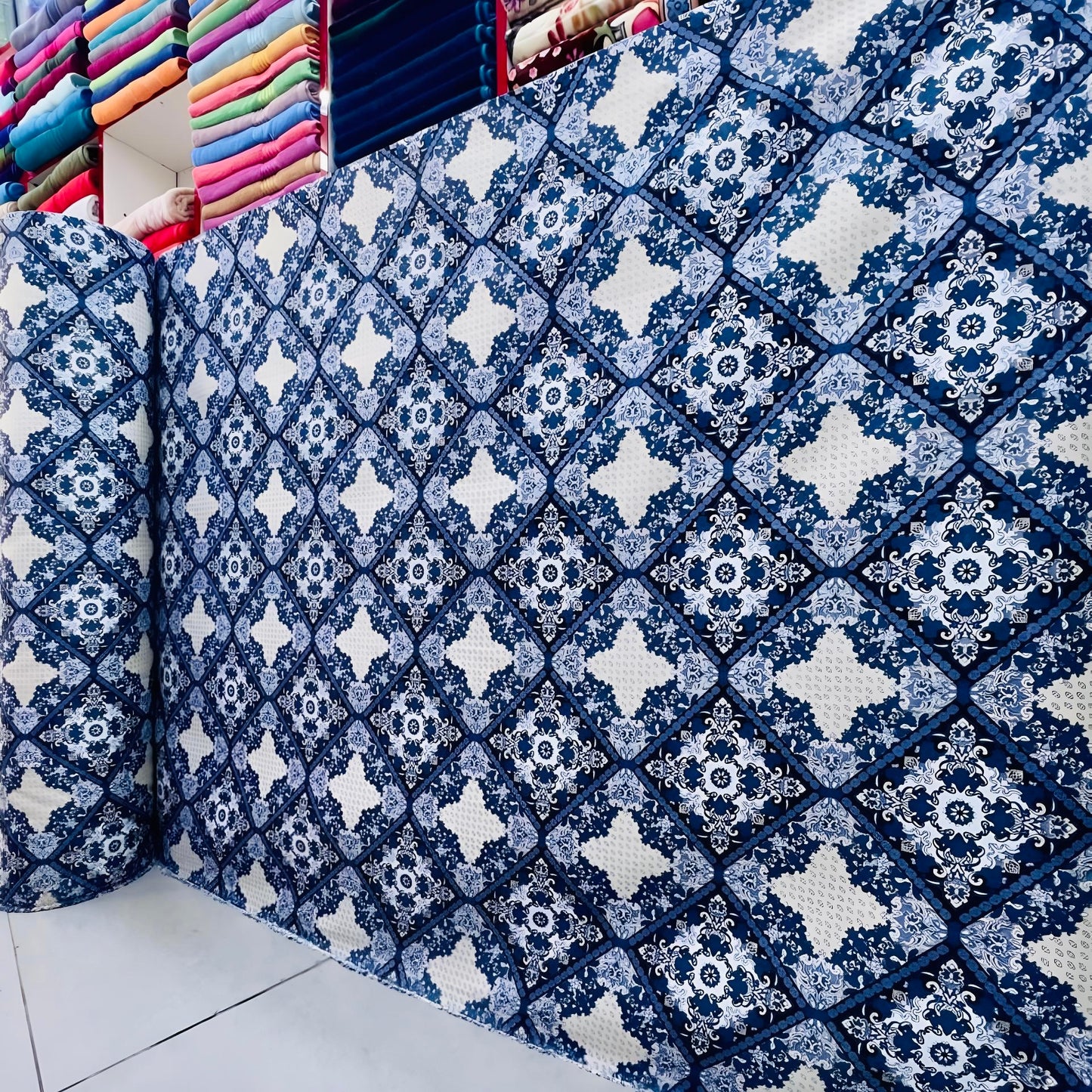 Premium blue printed bedsheet fabric roll for wholesale with elegant geometric floral design for custom bedding.
