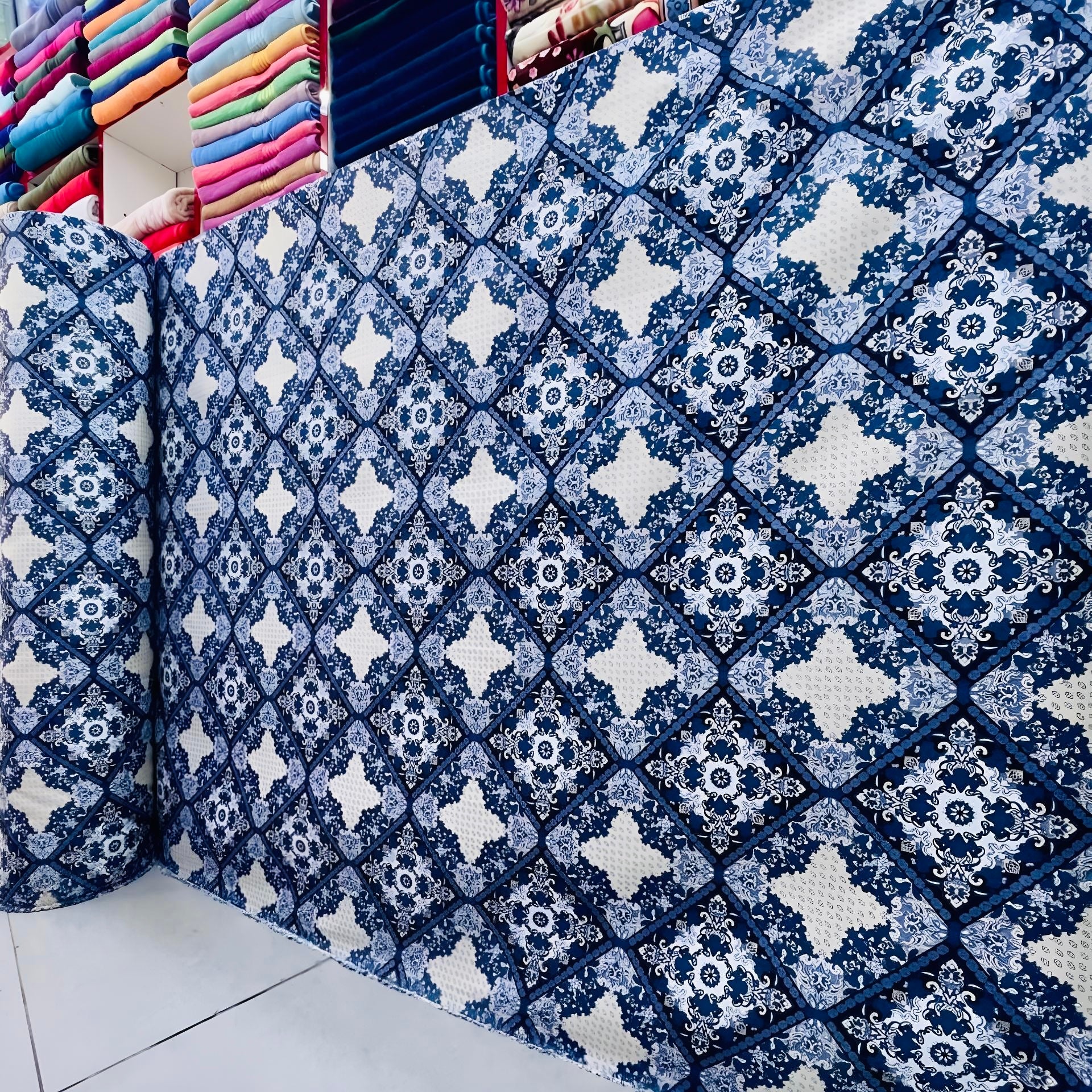 Premium blue printed bedsheet fabric roll for wholesale with elegant geometric floral design for custom bedding.