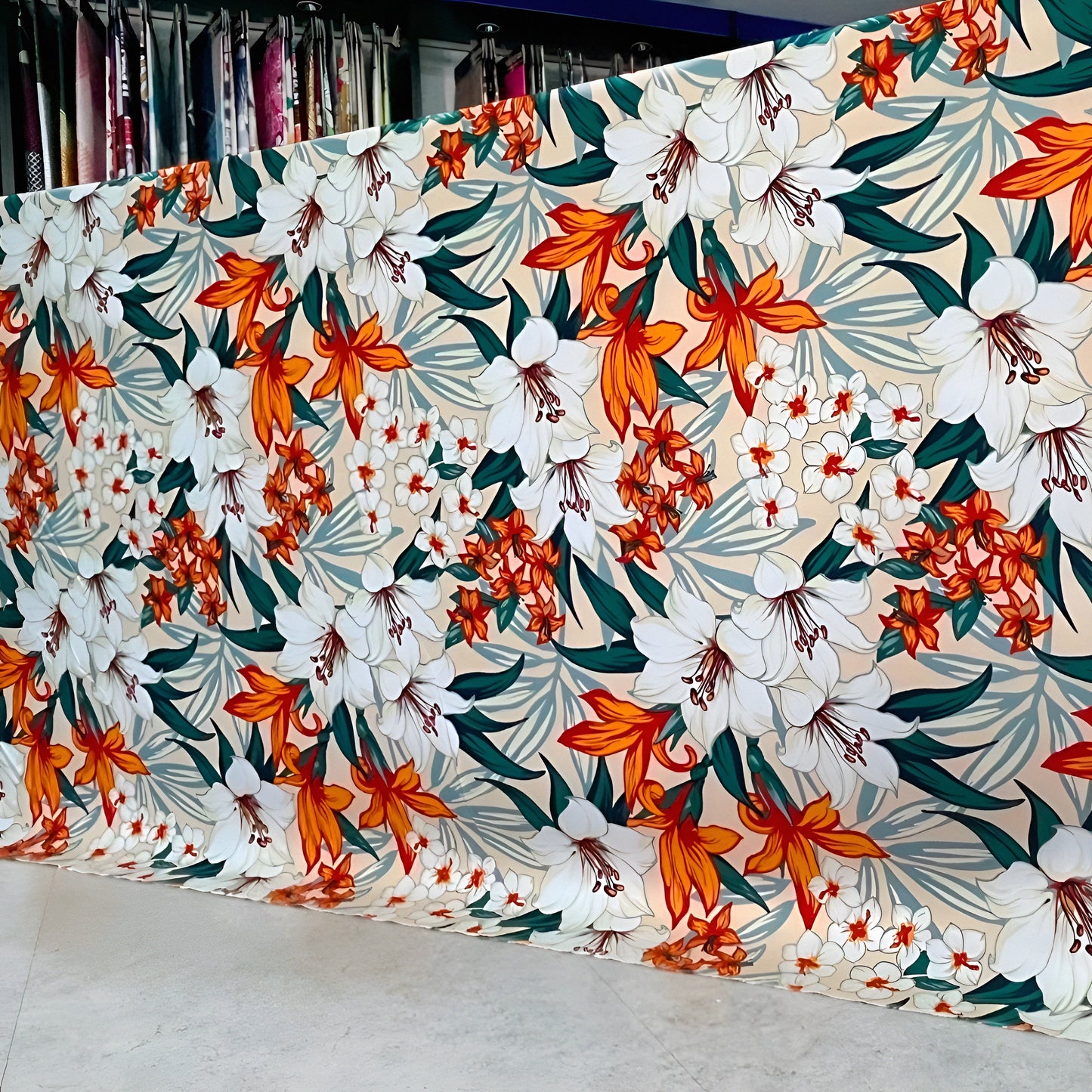 Marjan3x luxury floral bedsheet roll with white & orange lilies — wholesale sizes available. شرشف بنقشة زهور أبيض وبرتقالي، متاح بالجملة وبمقاسات متعددة
