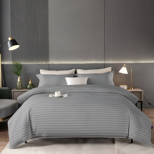 Gray striped bedding set on a bed in a modern bedroom with gray walls and decor.