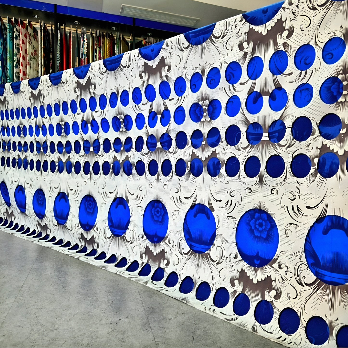 Royal blue floral polka dot printed cotton bedsheet displayed in showroom